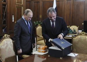 Russian Defence Minister Shoigu presents to President Putin the parametric flight recorder of the downed SU-24 jet at the Novo-Ogaryovo state residence outside Moscow